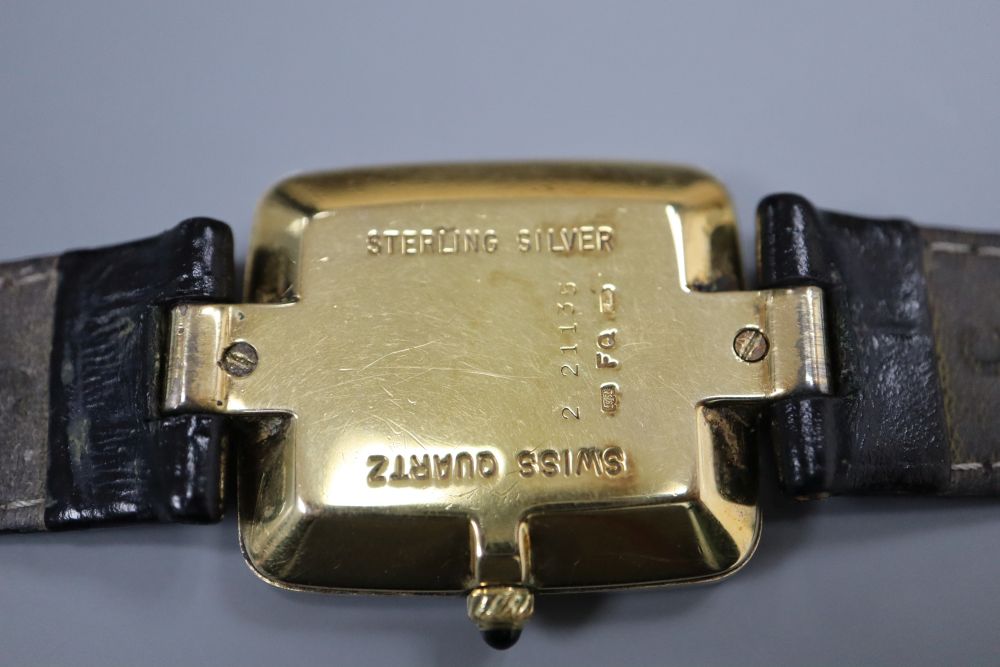 A gentlemans stylish modern silver gilt Dunhill quartz wrist watch, with rectangular Roman dial, on leather strap, with Dunhill buckle